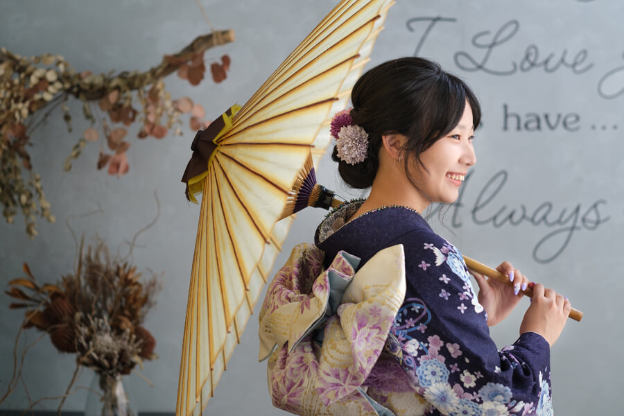 三愛フォトスタジオの成人記念写真。和傘を持った女性。